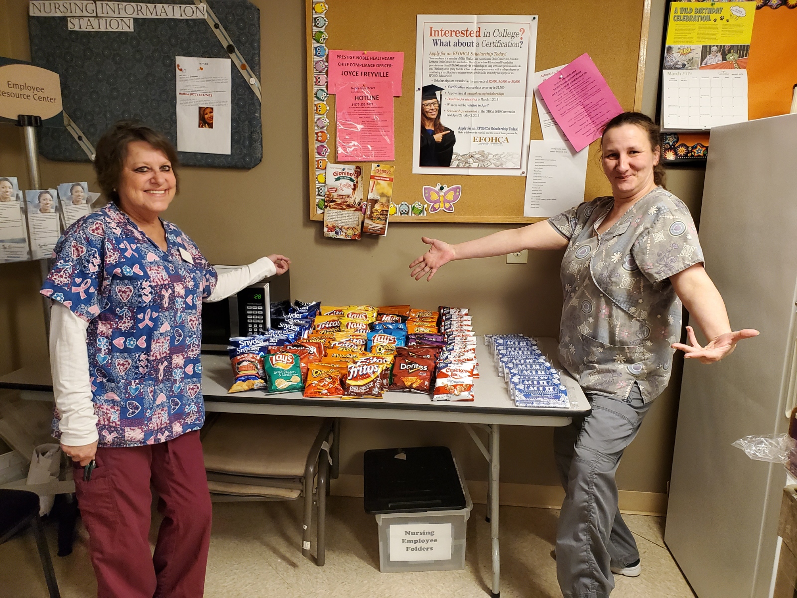 staff members with the chips and popcorn and snacks on table