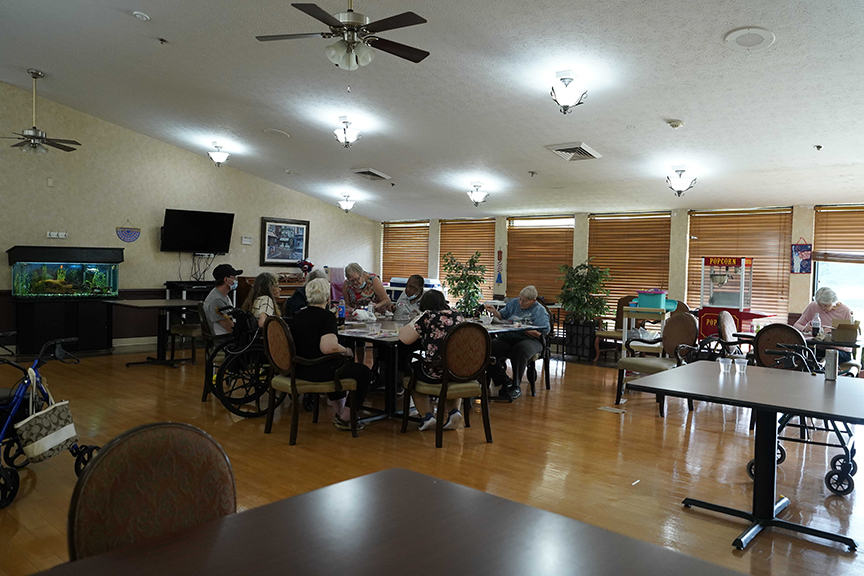 Dining table with people gathering in dining room- Arbors at Streetsboro